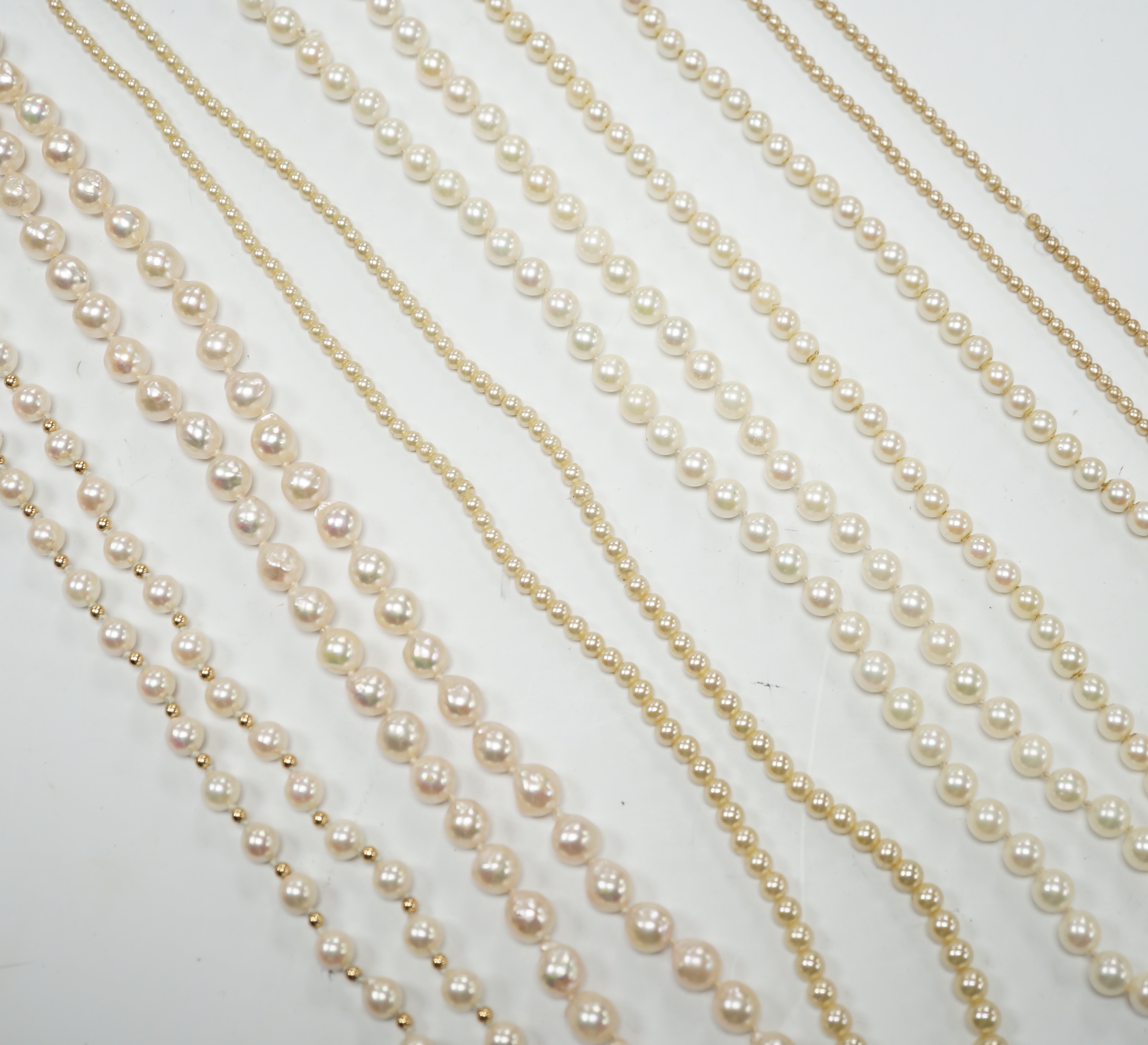 Five assorted single strand cultured pearl necklaces, including four with 9ct clasps, largest 47cm and one other simulated pearl necklace.
